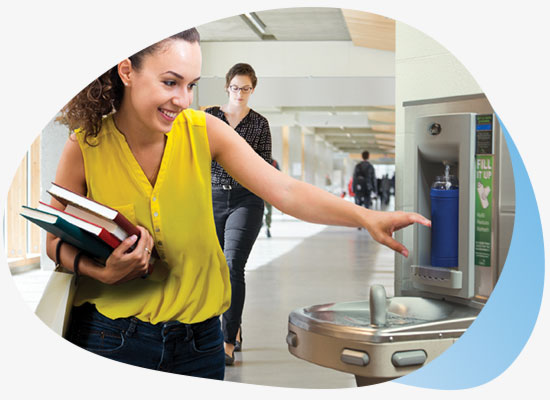 Lady reaching for fresh drinking water from bottle filling station